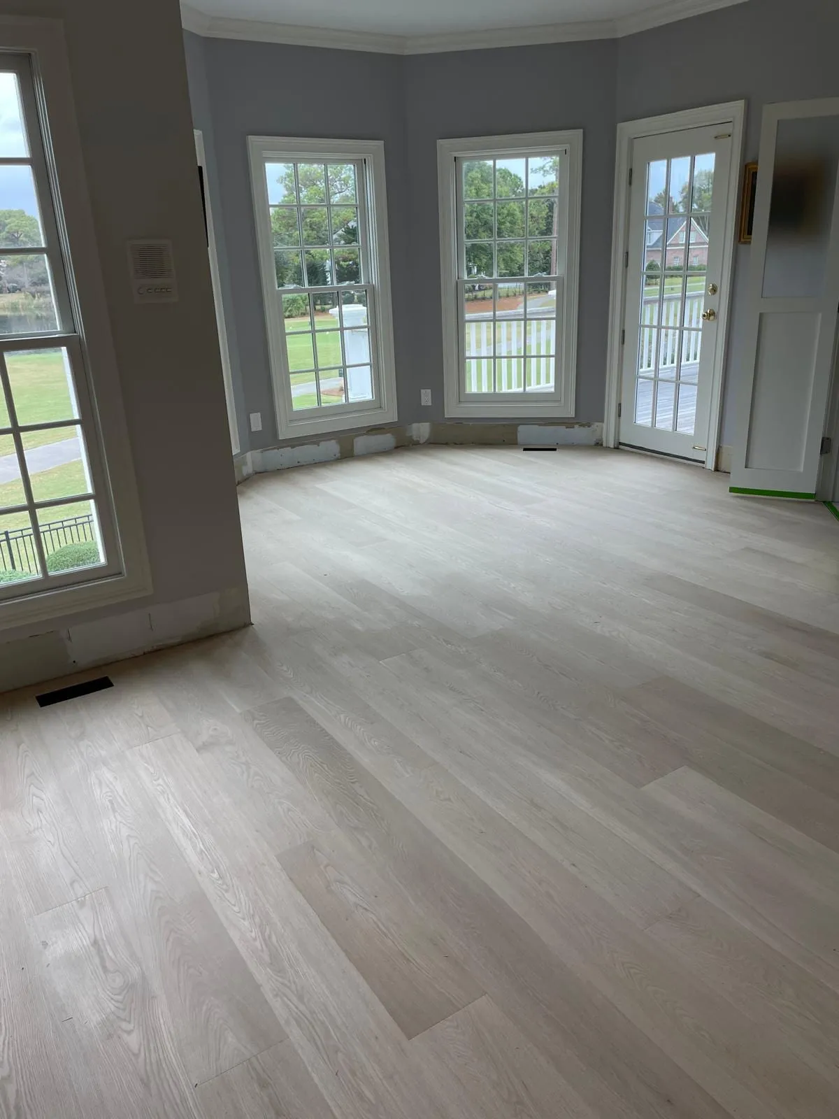 Finished engineered hardwood flooring in a bright Wilmington, NC living room