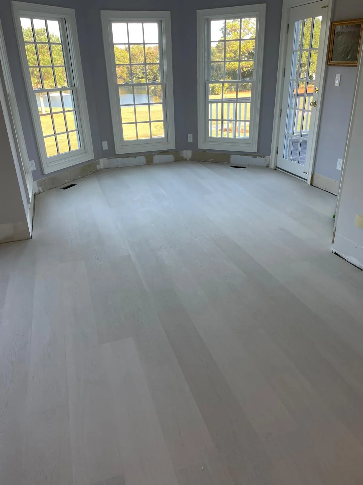 New hardwood floor running through the doorway into the next room