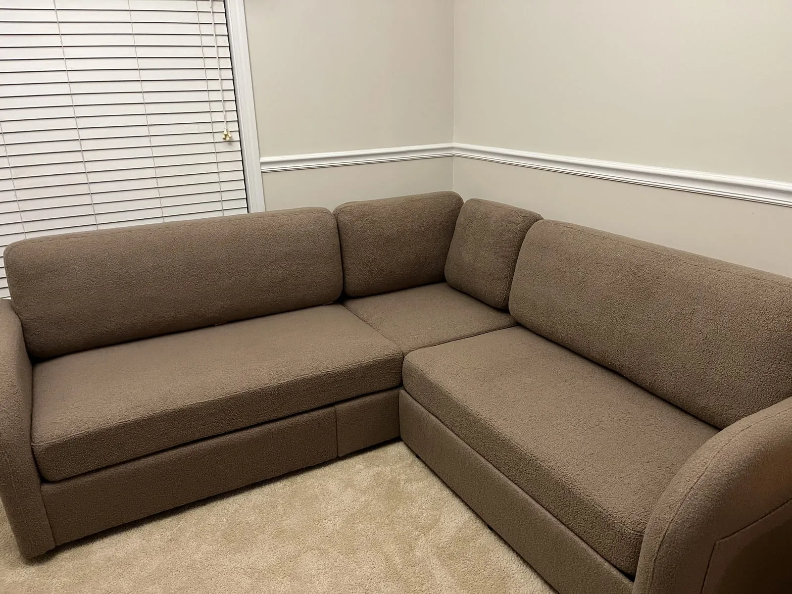 Assembled sectional sofa arranged in a living room