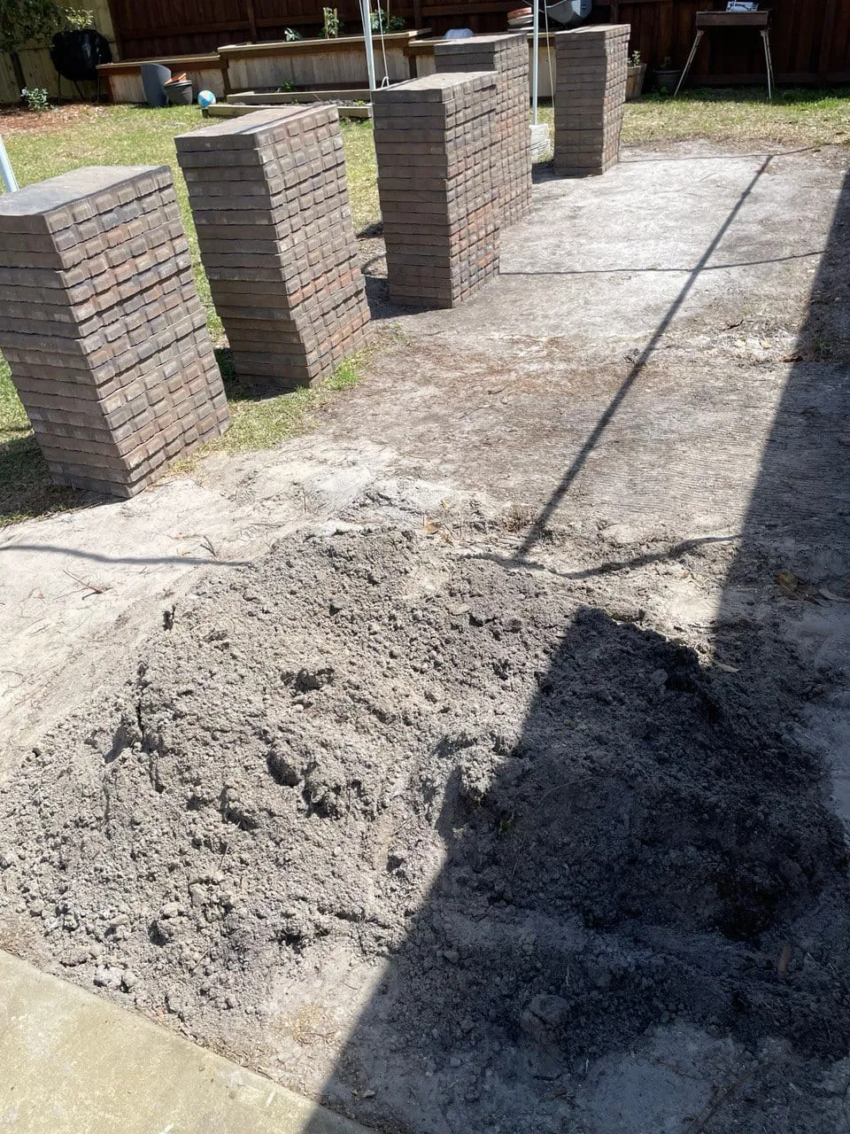 Excavated ground and prepared base before the pavers were installed