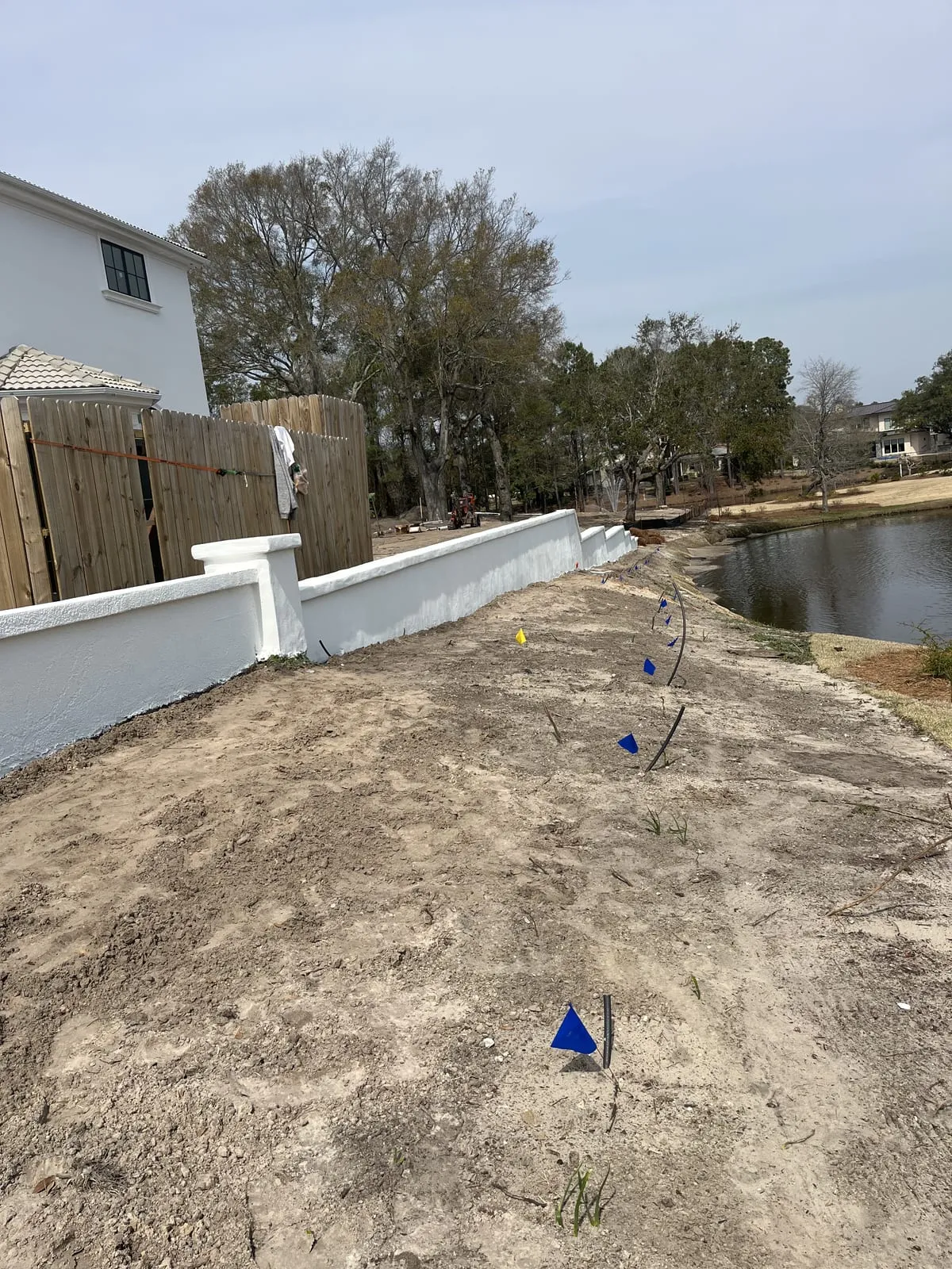 Completed white wall running along the water’s edge