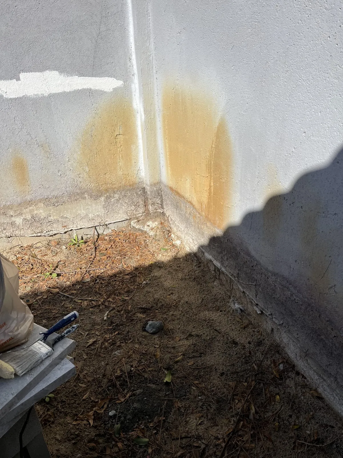 Discoloured and patchy wall surface before repainting